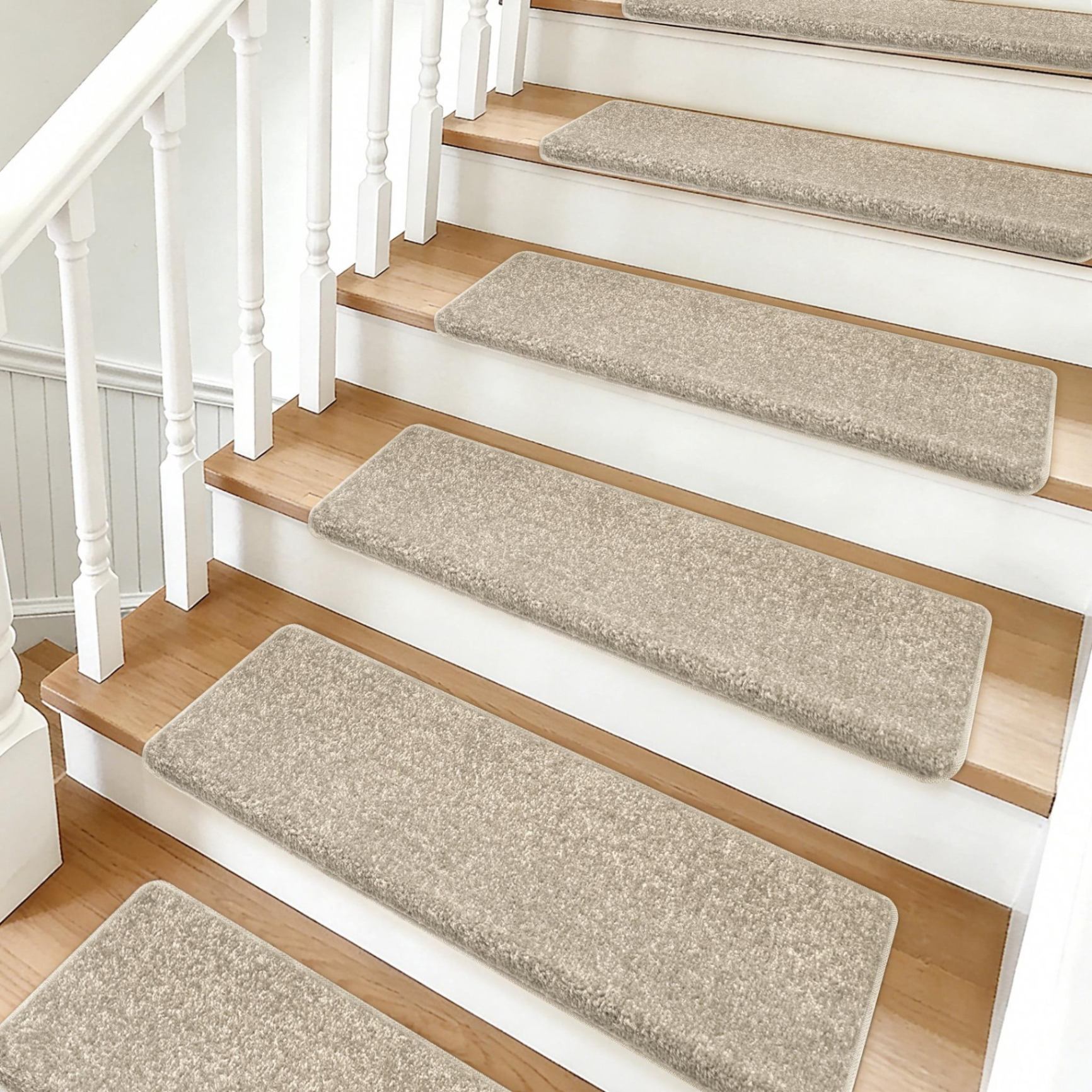 Plain beige loop-pile stair tread mats on a staircase with white balustrade